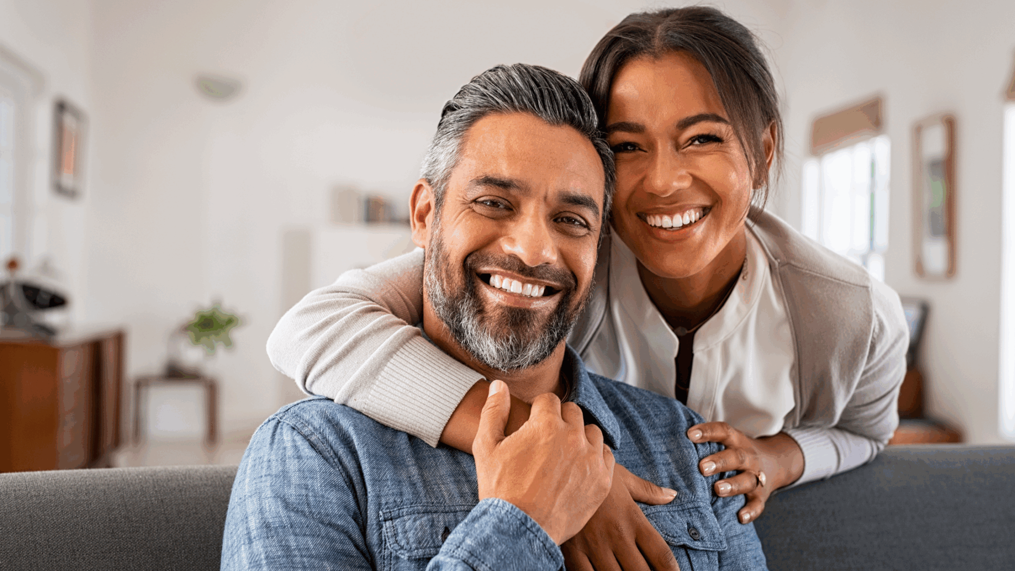 Smiling couple relaxing together on a couch at home