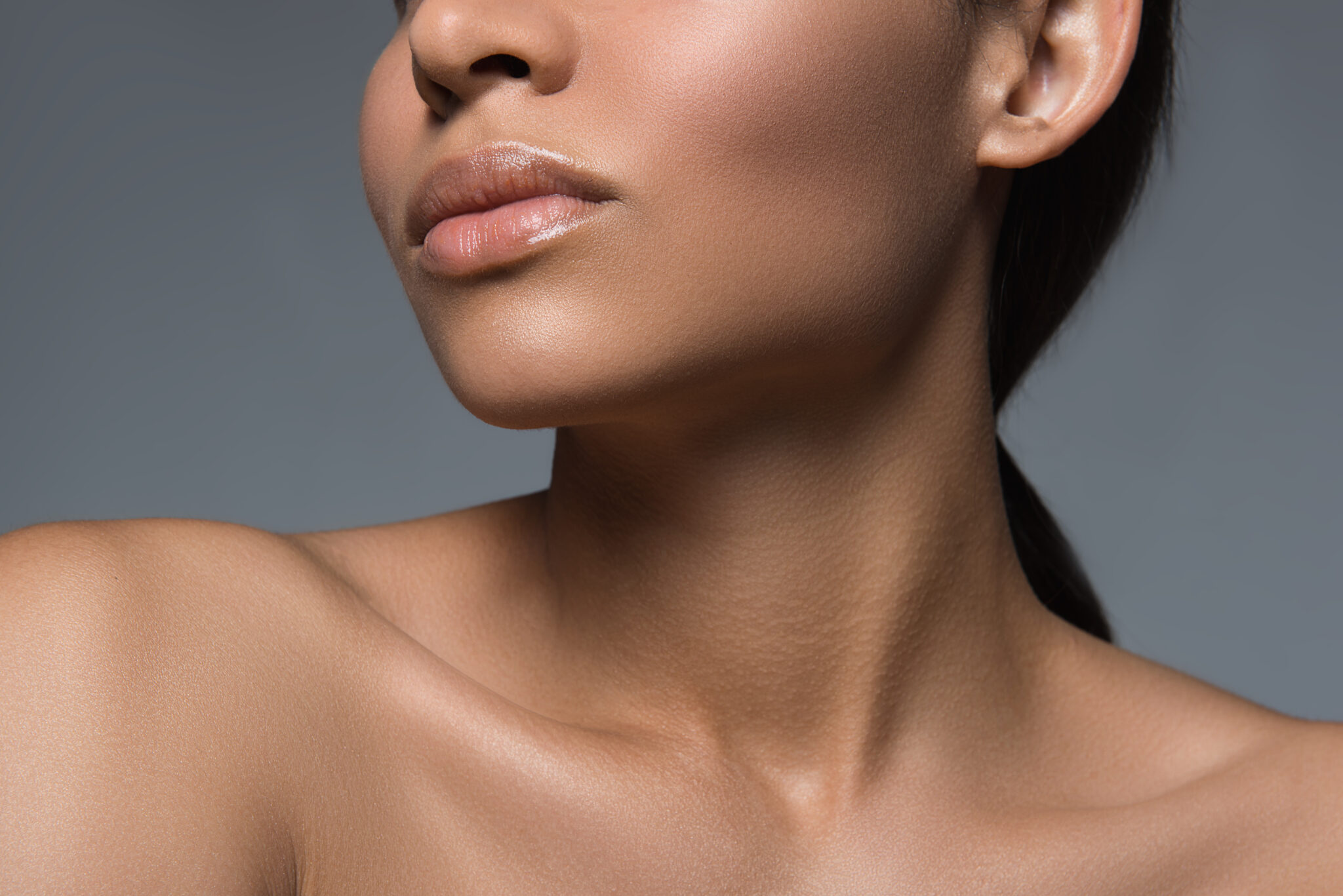 Woman's defined jawline and smooth neck in profile